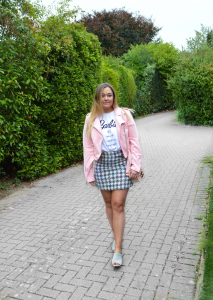 Hannah wearing Missguided x Barbie T Shirt with pink jacket and tweed skirt